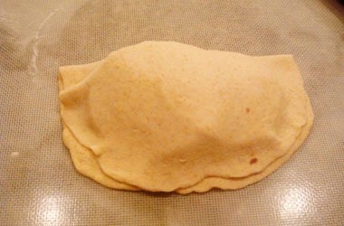 Unbaked calzone without crimped edges.