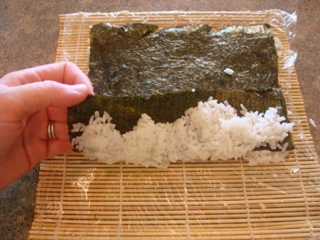 white rice being wrapped up in nori