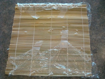 bamboo mat with plastic wrap taped on 