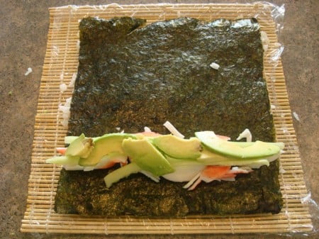 crab meat, cucumber, and avocado on a sheet of nori