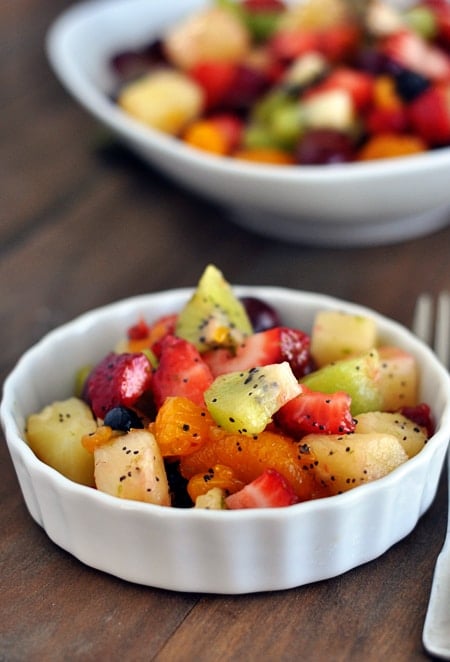 honey lime fruit salad in a white ramekin