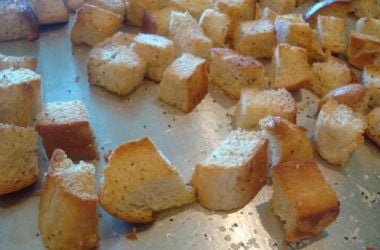 baked bread cubes on a metal cookie sheet