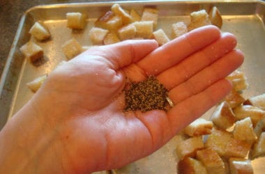 handful of cracked black pepper over a sheet pan of bread cubes