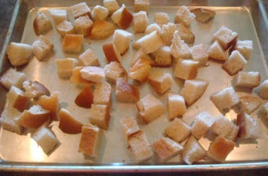 unbaked bread cubes on a cookie sheet