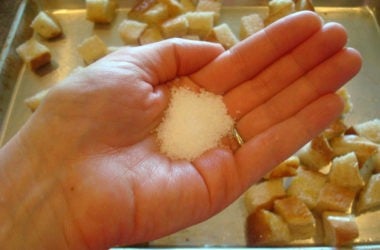 handful of coarse salt over a pan of bread cubes