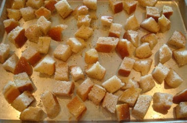 unbaked bread cubes on a metal cookie sheet