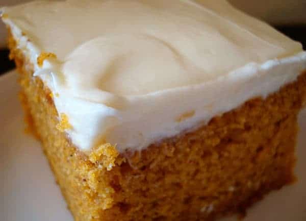 Frosted pumpkin bar on a white plate.