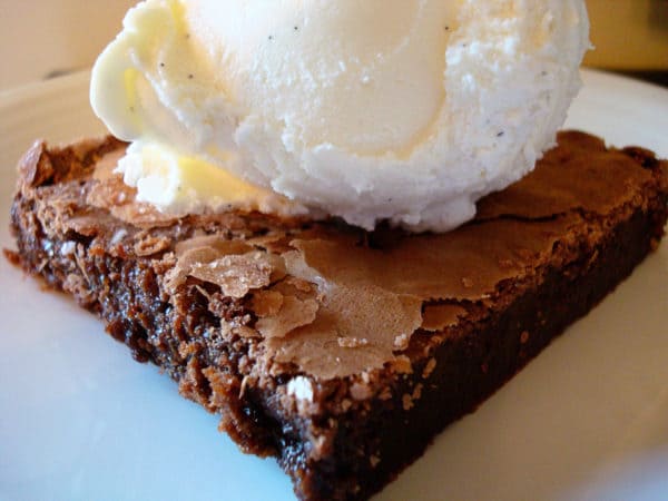 Brownie with a scoop of vanilla ice cream on top.