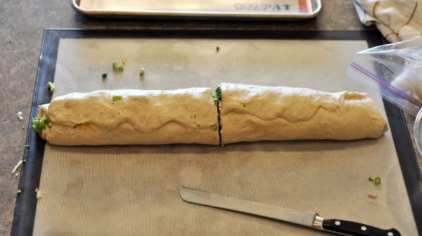 log of bread dough cut in half