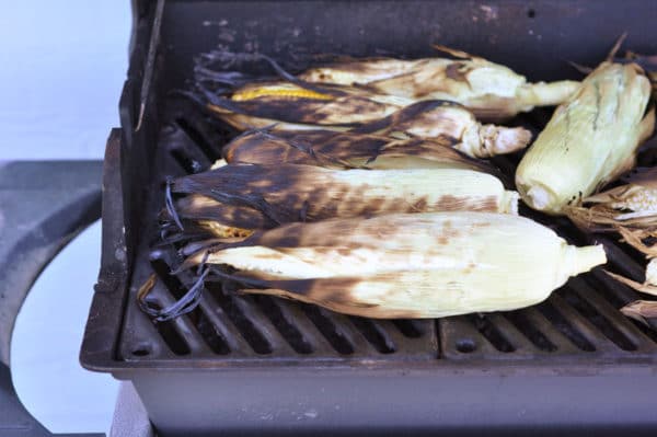 corn on the cob being grilled on a grill