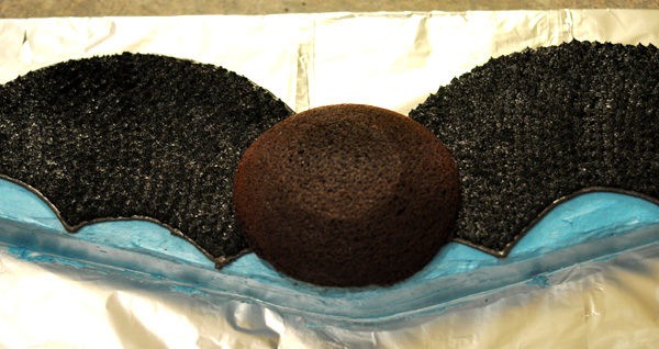 chocolate bat cake with black frosted wings and a small chocolate cake head