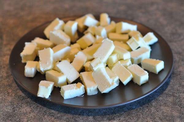cubed up butter on a black plate