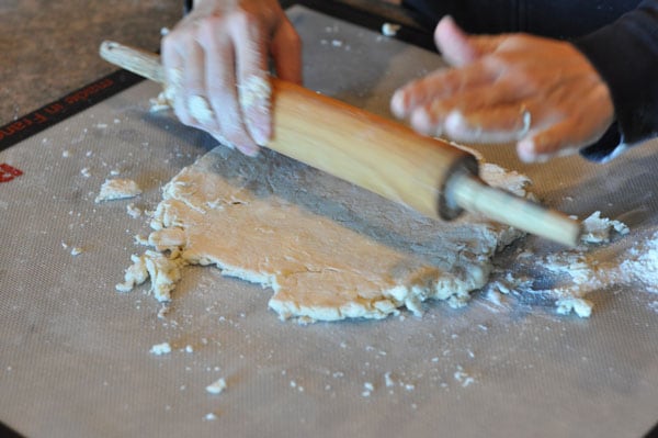 pie crust being rolled out with a rolling pin