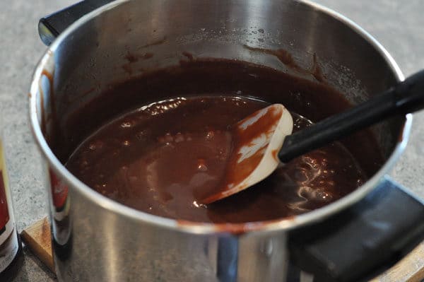 chocolate caramel mixture in a pot with a rubber spatula