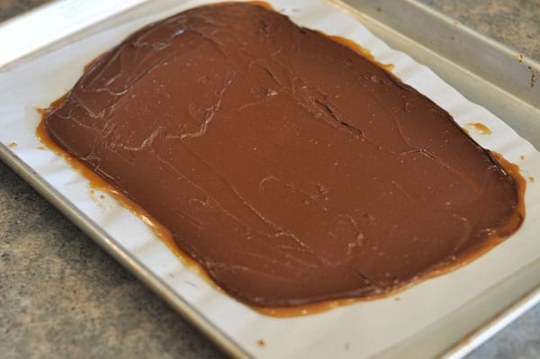Chocolate covered toffee in a big slab on a cookie sheet.