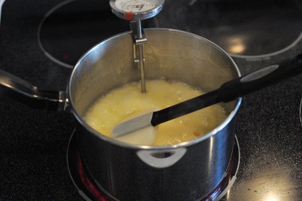 Pot with melted butter and a candy thermometer clipped to the side.