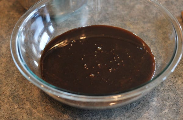dark colored fudge mixture in a glass bowl
