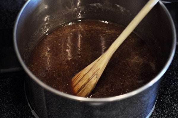 melted sugar in a saucepan with a wooden spoon