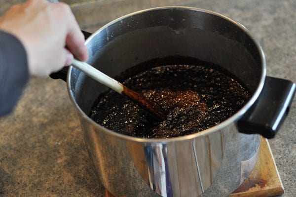 wooden spoon stirring a bubbling fudge mixture