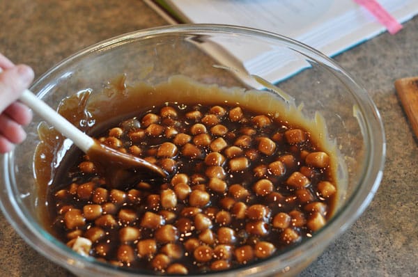 dark colored fudge with marshmallows mixed in in a glass bowl