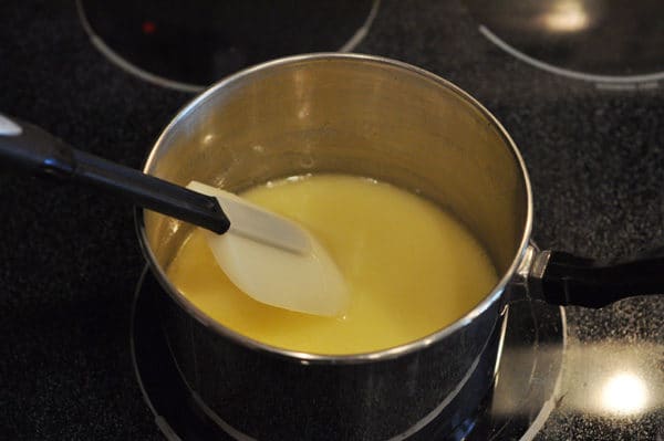 melted butter in a saucepan with a spatula in the pan as well