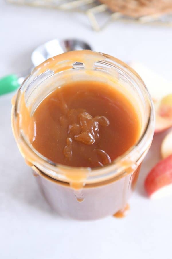 Homemade caramel sauce in glass jar.