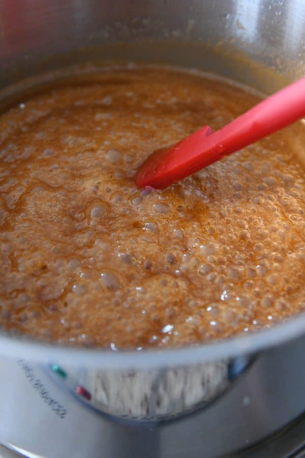 stirring homemade caramel sauce