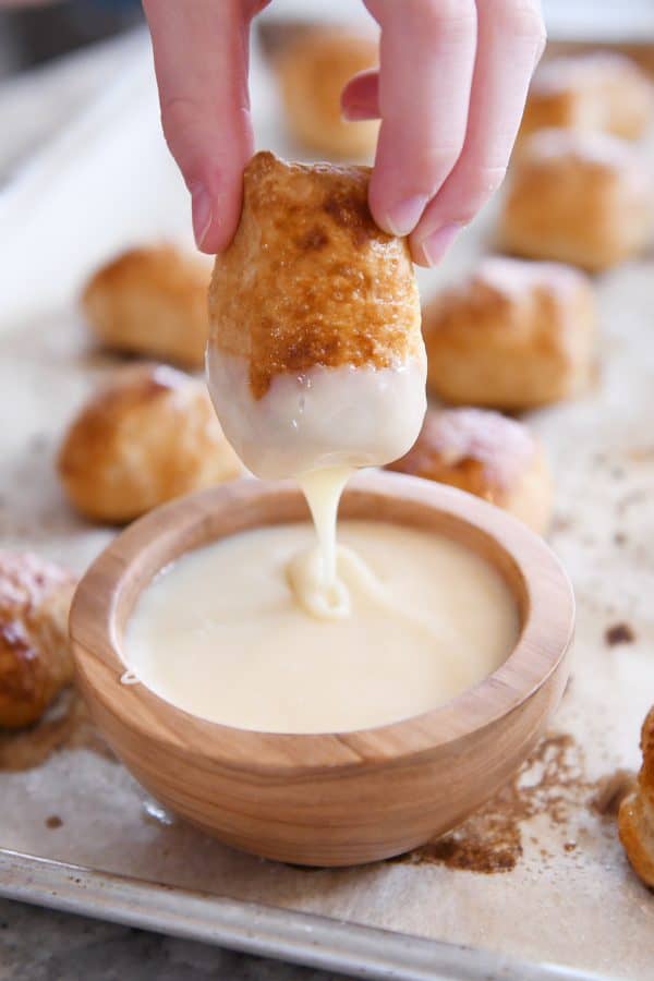 dipping easy homemade soft pretzel bites in homemade cheese sauce