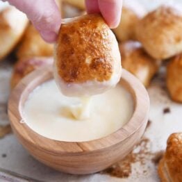 dipping easy homemade soft pretzel bites in homemade cheese sauce