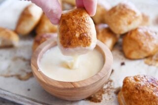 dipping easy homemade soft pretzel bites in homemade cheese sauce