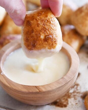 dipping easy homemade soft pretzel bites in homemade cheese sauce