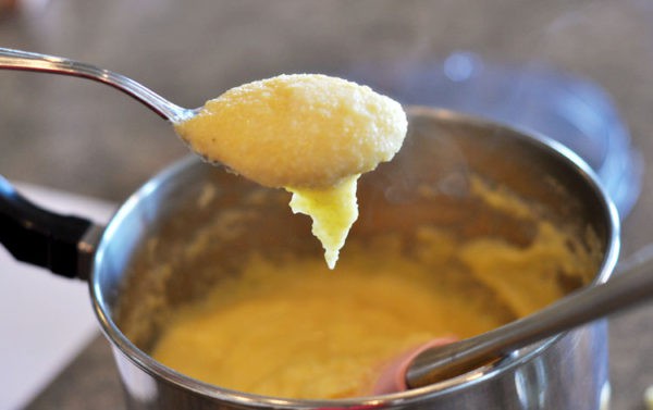 a pot with a butter and cornmeal mixture