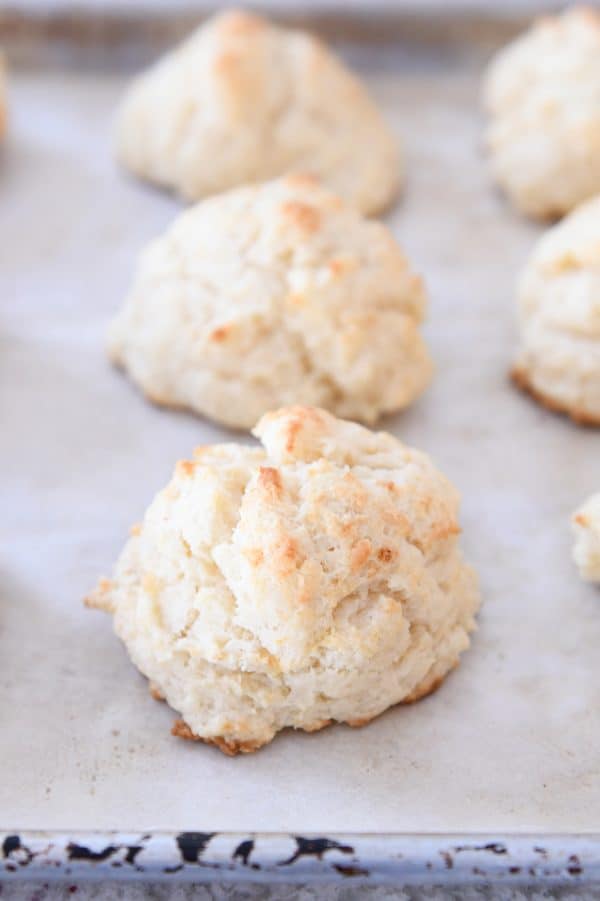 Baked flaky buttermilk drop biscuits on sheet pan.