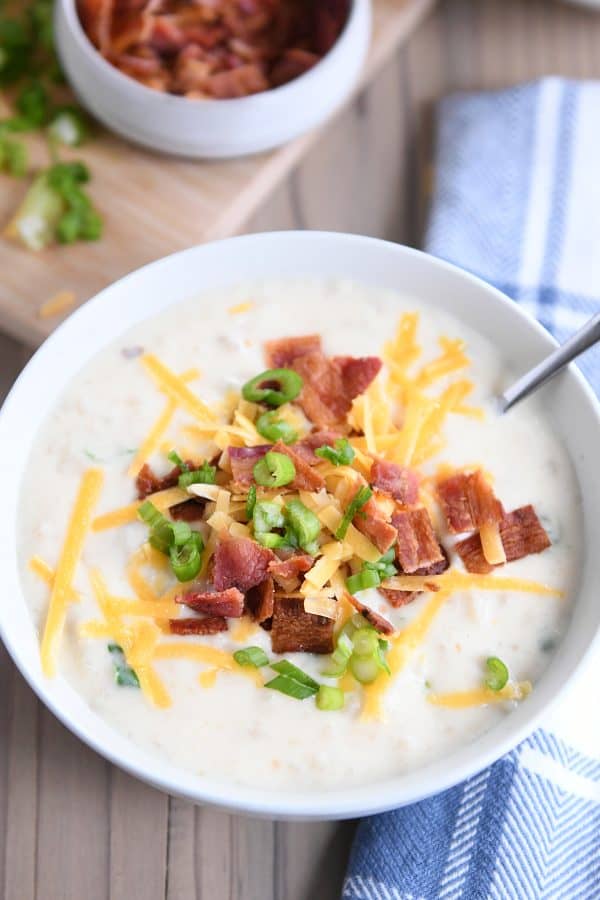 Top down view of easy loaded baked potato soup in white bowl.