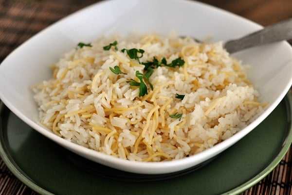 White bowl with cooked rice and pilaf.