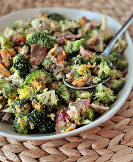 Full bowl of homemade broccoli salad with a spoonful of it on top.