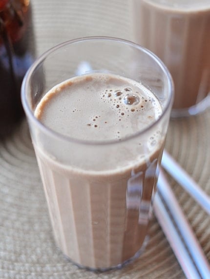 Top view of a tall skinny glass of chocolate milk.