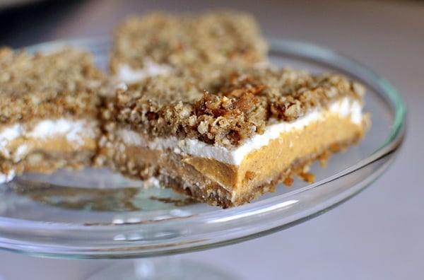 Pumpkin Crumble Cheesecake Bars cut up on a glass platter. 