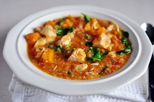 White bowl with chicken and butternut squash quinoa stew.