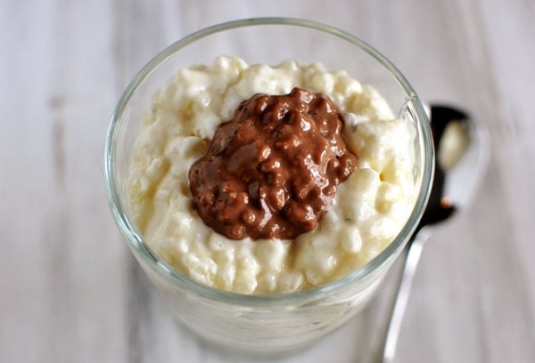 Top view of a glass goblet with cheesesteak rice pudding and chocolate rice pudding in the middle.