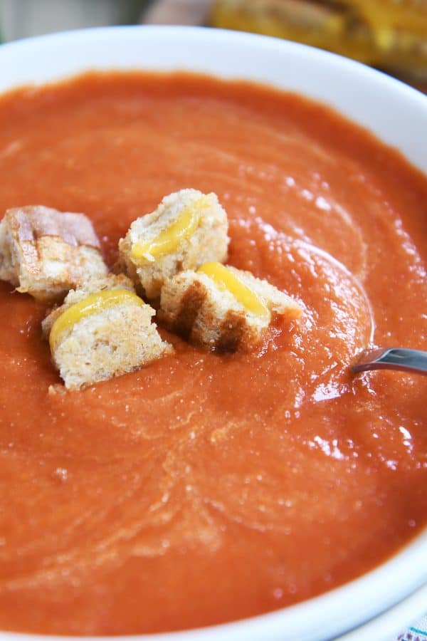Bowl of classic tomato soup with grilled cheese croutons.