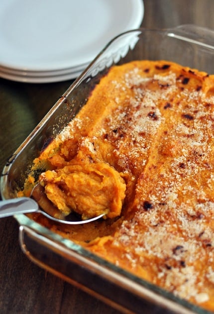 Top view of a clear casserole dish with cooked sweet potato casserole.