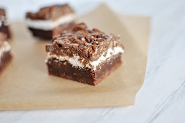 brownie bottom, marshmallow middle, and crunchy topped chocolate bar cut in a small square