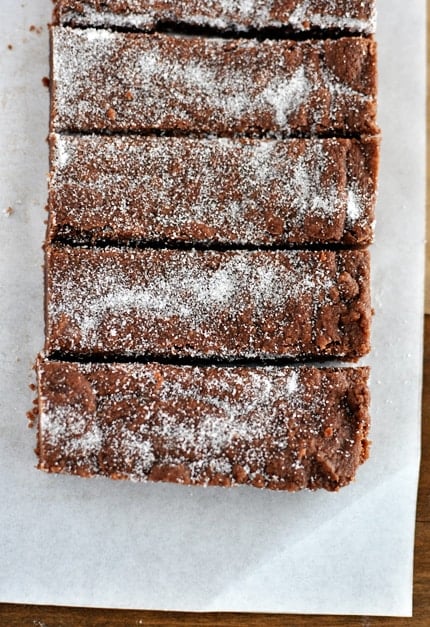 Top view of powder sugar dusted chocolate shortbread fingers cut into rectangles.