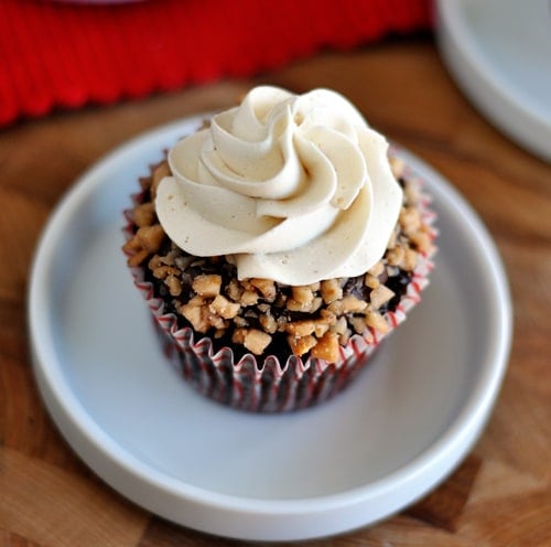 Top view of a frosted and toffee topped chocolate cupcake.