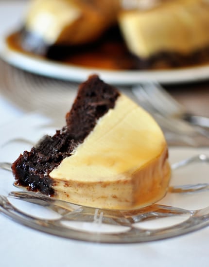 A piece of cake with a chocolate cake bottom and flan top on a glass plate.