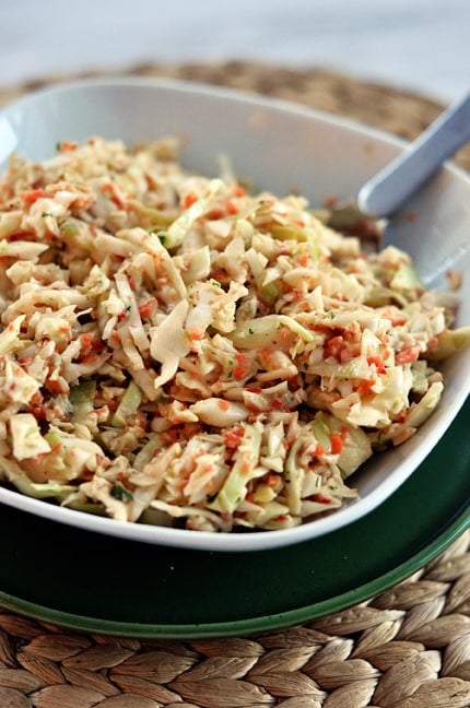 Top view of a white dish full of coleslaw.