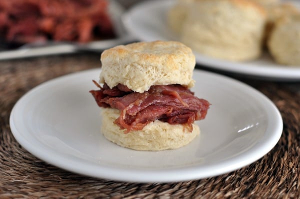 a cooked biscuit with shredded ham in the middle