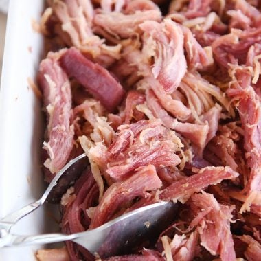 shredded sweet baked ham in white baking dish