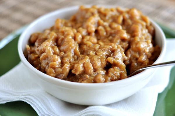 A white bowl full of boston baked beans.